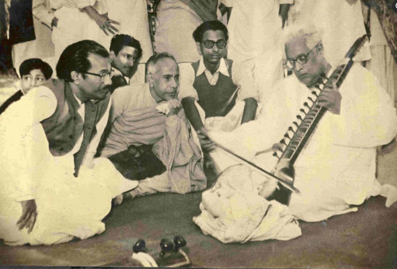 People listening to the Esraj music, played by S. N. Bose
